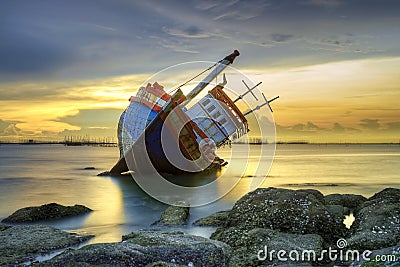 Shipwreck at sunset Stock Photo