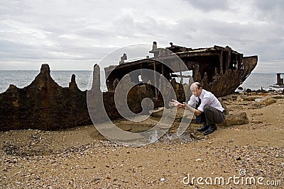 Shipwrecked and bankrupt businessman Stock Photo