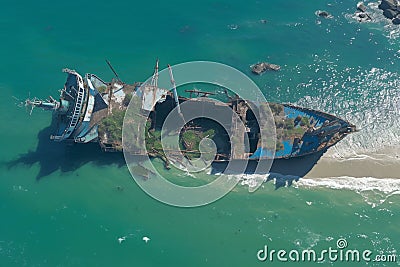 Shipwrecked tanker abandoned by coast, hinting at maritime past Stock Photo
