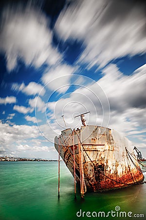 Shipwrek in the harbor - long exposure - color version. Stock Photo