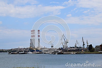 A shipyard with cranes in the background. Editorial Stock Photo
