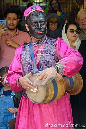 Dancers musicians with black face dance in the street in Bazaar to spread good cheer in Nowruz holidays. Shiraz. Iran Editorial Stock Photo