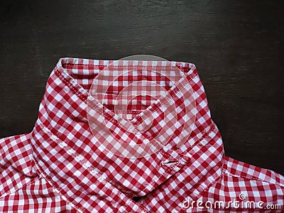 Shirt plaid pattern collar placed on a wooden table. Stock Photo