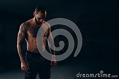 Shirtless concentrated male athlete looking to the floor Stock Photo