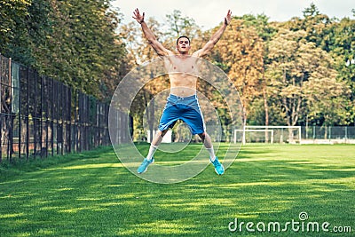 Shirtless handsome man working out in park, cross fit training. Athletic man jumping and doing exercises outdoor Stock Photo