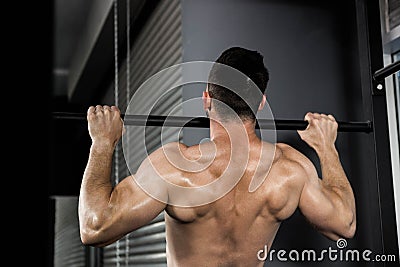 Shirtless man doing pull up Stock Photo
