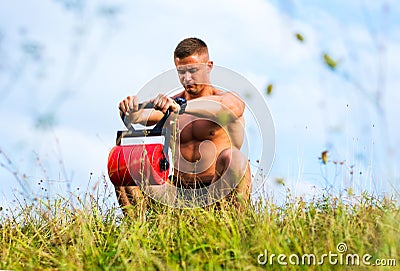 Masculine man exercising outside with a weight Stock Photo