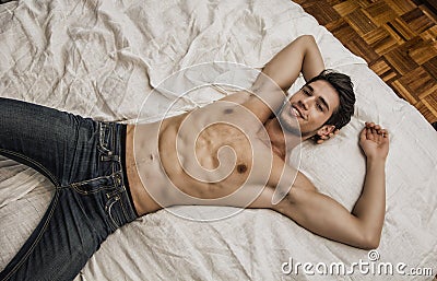 https://thumbs.dreamstime.com/x/shirtless-sexy-male-model-lying-alone-his-bed-young-smiling-man-bedroom-looking-camera-seductive-attitude-67229963.jpg