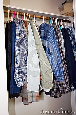 Shirts hanging in a closet Stock Photo