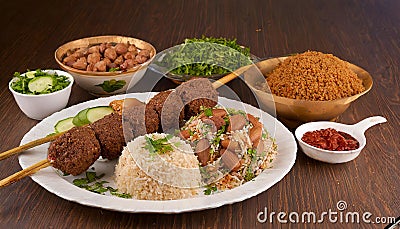 Shish kebab with mixed rice, kibbe and variety of ethnic lebanese food. Stock Photo