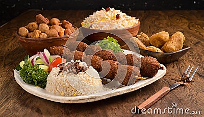 Shish kebab with mixed rice, kibbe and variety of ethnic lebanese food. Stock Photo