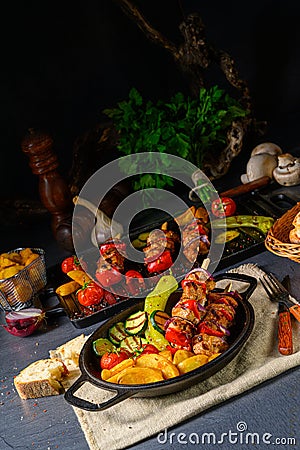 Shish kebab with various vegetables and spice country potatoes Stock Photo