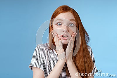 Shit bummer. Shocked worried young intense serious-looking confused young redhead girl look stressed nervously touching Stock Photo