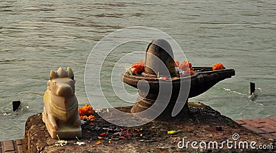 Shiva Linga and sacred bull statue on the Ganges river bank Stock Photo