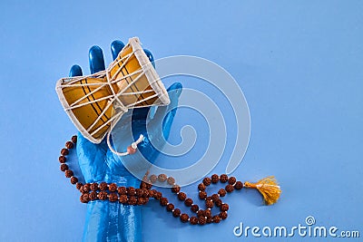 Shivaratri background with Shiva hand and Drum Damroo musical instrument. Maha Shivratri festval. Stock Photo
