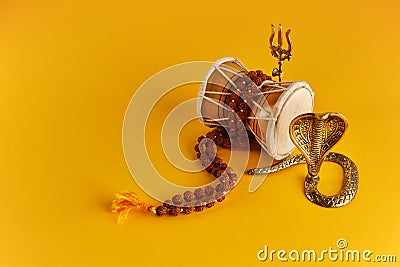 Shivaratri background with Shivas trident, Pellet Drum Damroo musical instrument ans snake . Maha Shivratri festval Stock Photo