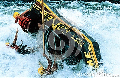 A shock moment on the Zamezi river - a capzising raft in the powerful whitewater of the Zambezi Editorial Stock Photo