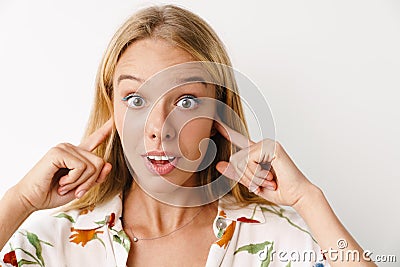 Shocked beautiful girl plugging her ears while posing at camera Stock Photo