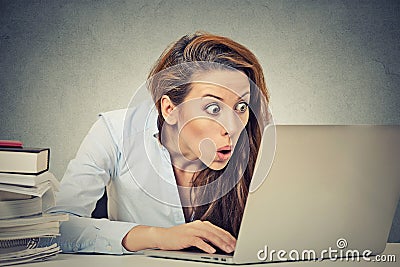 Shocked business woman sitting in front of laptop computer Stock Photo