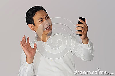 Shocked Businessman with Cell Phone Stock Photo
