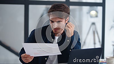 Shocked businessman finding mistakes in documents. Upset man getting bad results Stock Photo