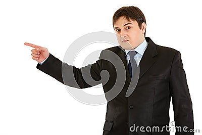 Shocked businessman pointing finger in corner Stock Photo