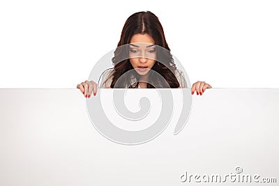 Shocked businesswoman looks down at message Stock Photo