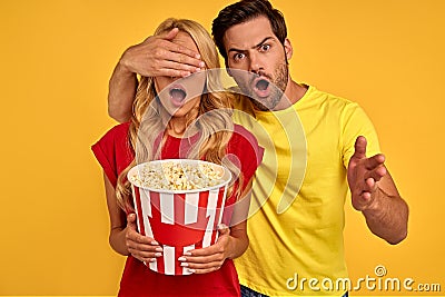 Shocked couple two friends guy girl in 3d glasses isolated on yellow background. People in cinema lifestyle concept. Watching Stock Photo