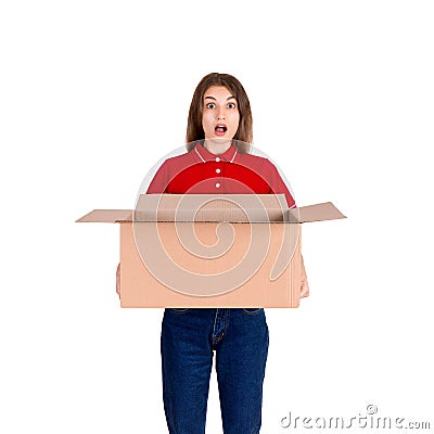 Shocked delivery girl is holding a big open parcel box isolated on white background Stock Photo