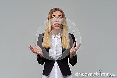 Shocked depressed angry business lady raises her hands to the side without understanding the reasons for failure Stock Photo