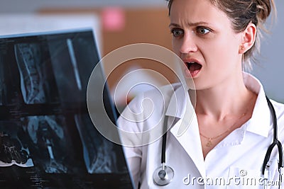 Shocked doctor looks at X-ray in clinic Stock Photo