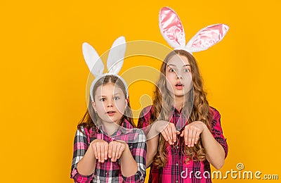 shocked easter children in bunny ears on yellow background Stock Photo