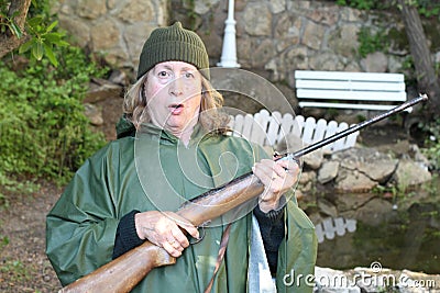 Shocked female hunter holding riffle Stock Photo