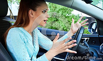 Annoyed woman driving a car Stock Photo