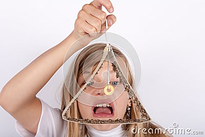 Shocked girl holding a moth trap full of trapped food moths Stock Photo