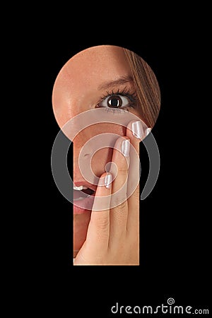 Shocked girl is looking in keyhole GN Stock Photo