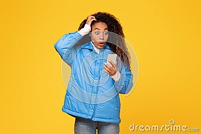 Shocked lady reads bad message on phone, touches head Stock Photo