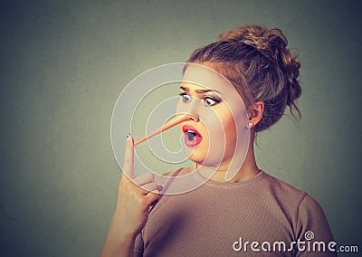 Shocked liar woman with long nose Stock Photo