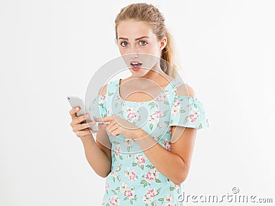 Shocked look at phone, portrait surprised young girl,woman looking at smartphone seeing bad news or photos with stunned emotion on Stock Photo