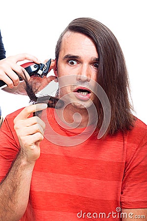 Shocked man being shaved with hair trimmer Stock Photo