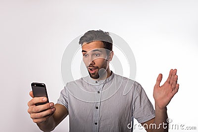 Shocked man government worker received horrifying news in text message on cellphone Stock Photo
