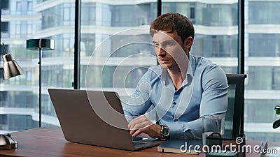 Shocked man reading bad news office. Big eyes businessman looking laptop screen Stock Photo