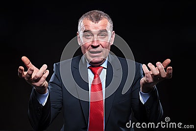 Shocked old business man gesturing in confusion Stock Photo