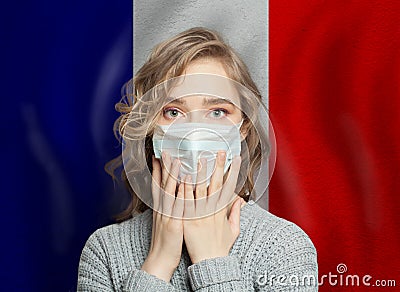 Shocked panicking woman in medical face mask with France background Stock Photo