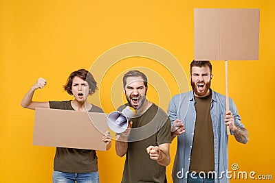 Shocked protesting young people guys girl hold protest signs broadsheet blank placard on stick scream in megaphone Stock Photo