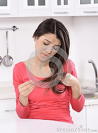 Shocked and sad woman - broken hair after coloration. Stock Photo