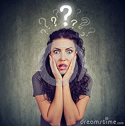 Shocked scared woman looking at camera has many questions Stock Photo