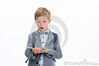 Shocked schoolboy using tablet Stock Photo