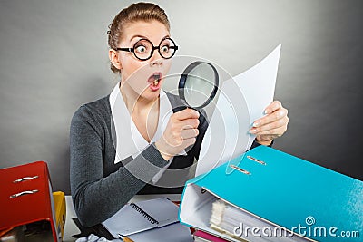 Shocked secretary examining documents. Stock Photo