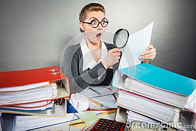 Shocked secretary examining documents. Stock Photo